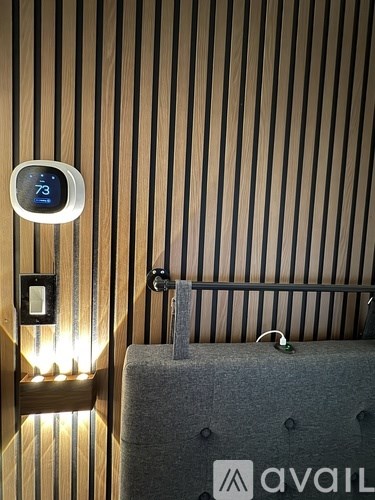 A wall-mounted thermostat shows the temperature as 73 degrees.