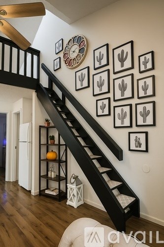 A staircase with a black railing and a white handrail.