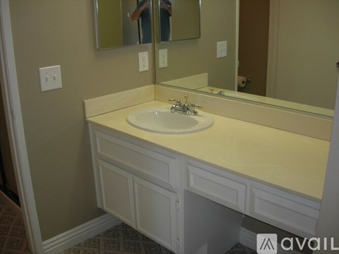 A bathroom with a sink and mirror.