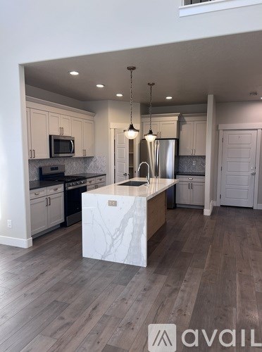 A kitchen with a marble island in the middle.