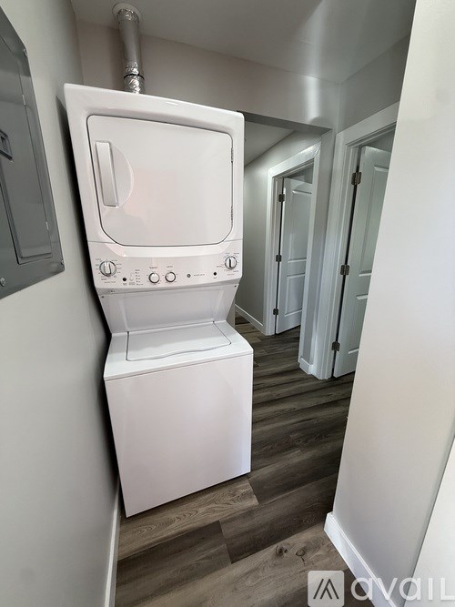 A white toilet with a tank and a pipe coming out of it.