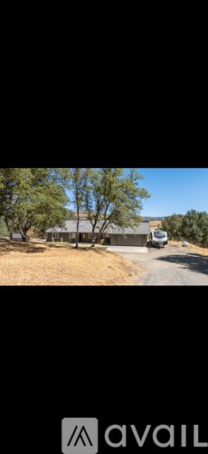 A house with a tree in front of it.