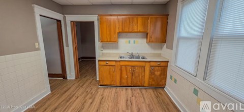 A kitchen with wooden cabinets and a white countertop.