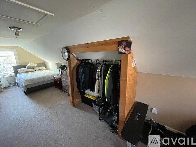 A bedroom with a large closet and a bed in the background.