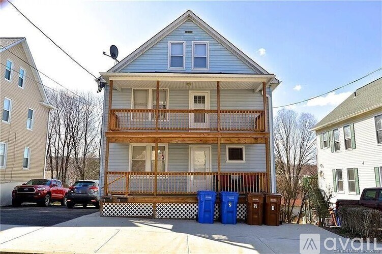 A two-story house with a balcony and a deck.
