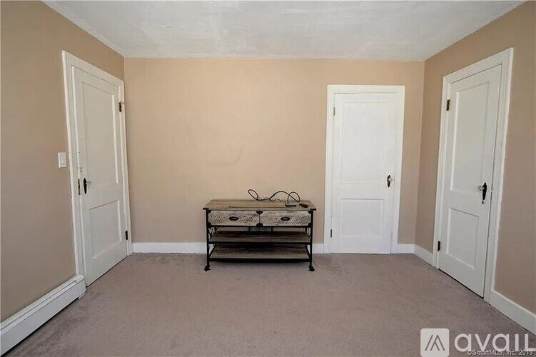 A room with a table and chairs in it.