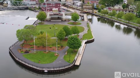 A small island with a park in the middle of a river.