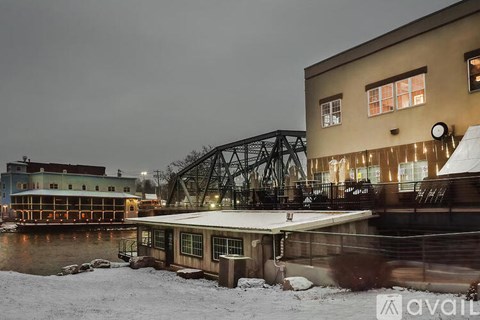 A bridge over a river with a building on the right.
