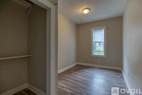 A room with a window and wooden flooring is available for rent.