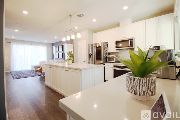 A modern kitchen with white cabinets and a large island.