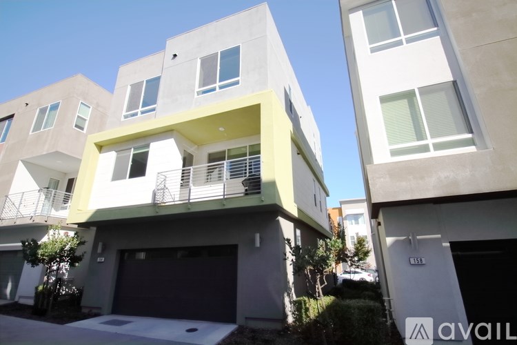A modern two-story house with a balcony and a garage.
