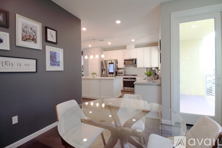 A modern kitchen with a dining table and chairs.