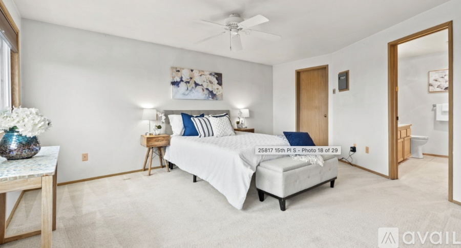 A bedroom with a bed, nightstand, and a ceiling fan.
