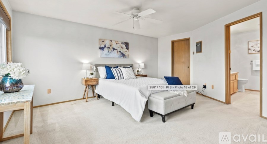 A bedroom with a bed, nightstand, and a ceiling fan.
