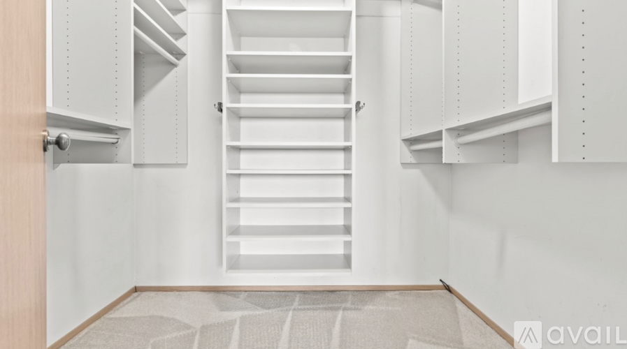 A white interior with a staircase and a door.