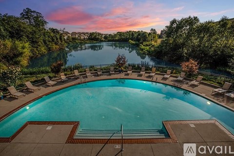 A kitchen with white cabinets and a black countertop.