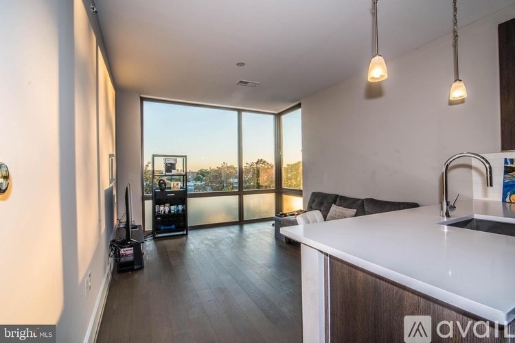 A modern kitchen with a large window overlooking a cityscape.