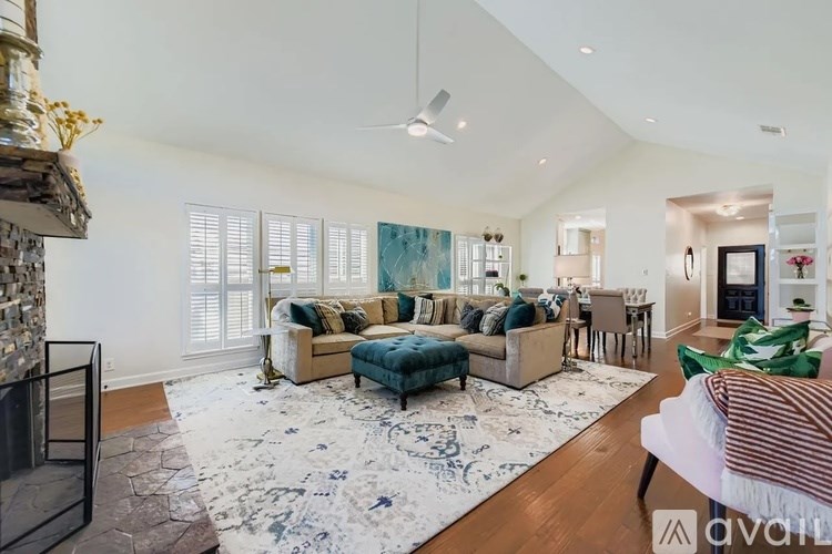 A living room with a fireplace and a rug.