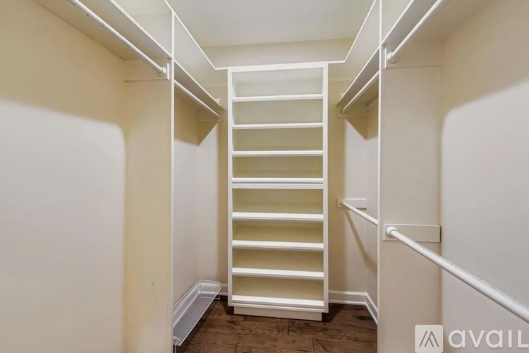 A white ladder in a narrow hallway.