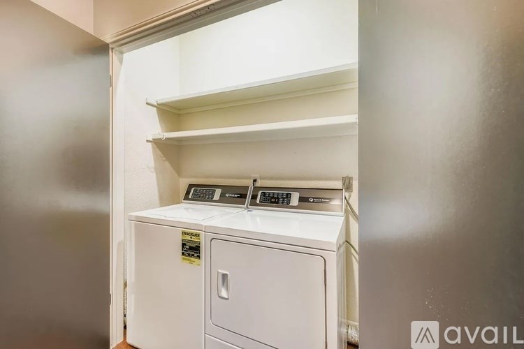 A small white cabinet with a microwave and oven on top of it.