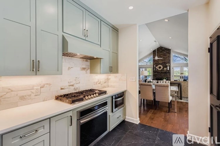 A modern kitchen with a view of a dining area.