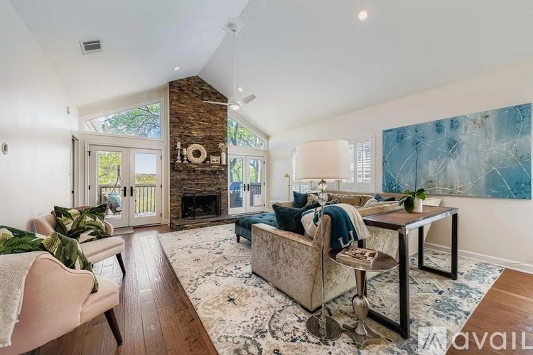 A living room with a fireplace and a painting on the wall.