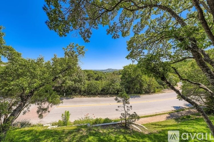 A view of a road through a natural landscape with trees.