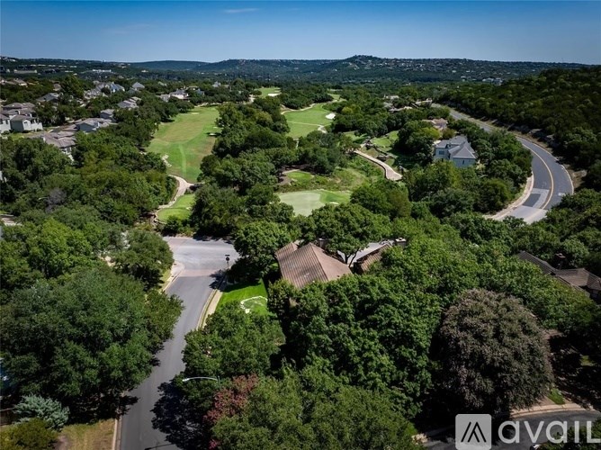 A bird's eye view of a residential area with a golf course.