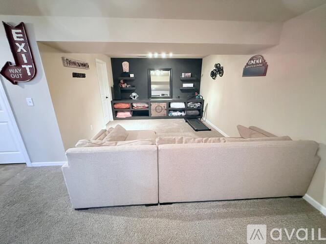 A bedroom with a bed, a mirror, and a shelf with various items on it.