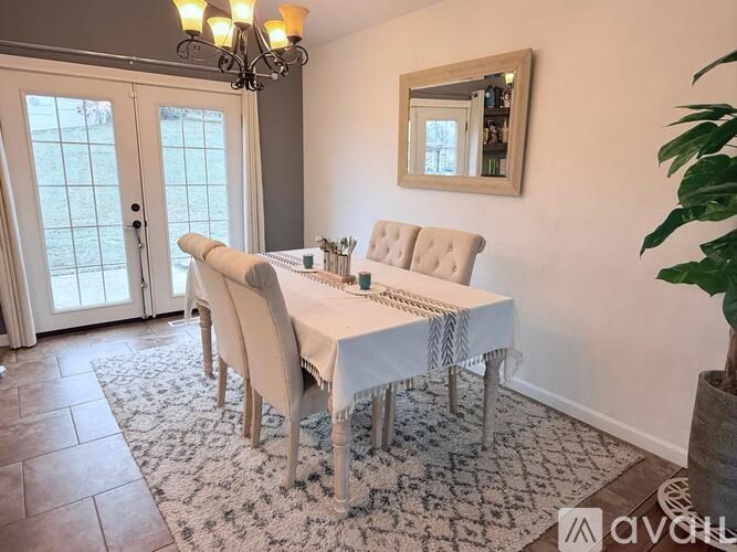 A dining room with a table set for four.