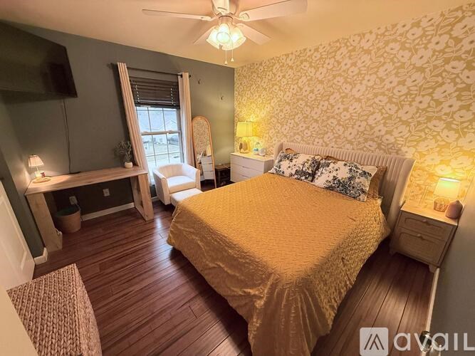 A bedroom with a bed, desk, and chair.