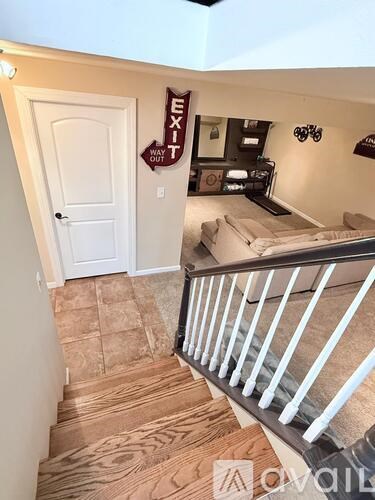 A room with a white door and a sign that says "Exit Way Out".