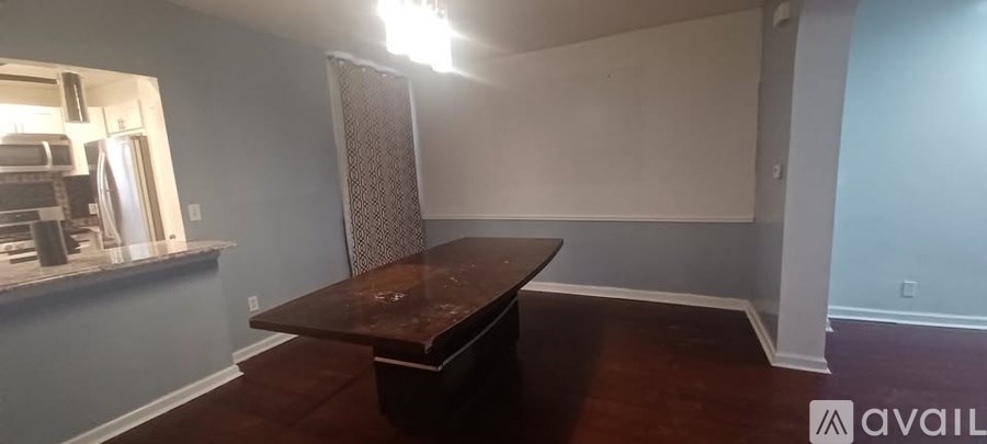 A room with a table and a wall with a window.