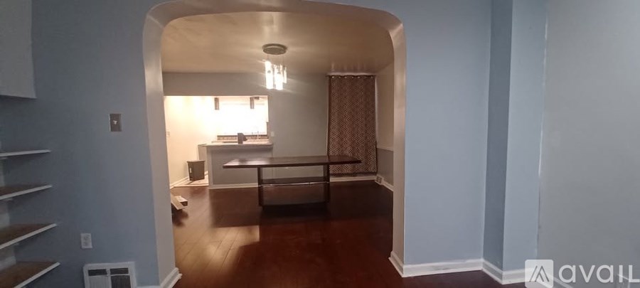 A living room with a couch and a dining table.