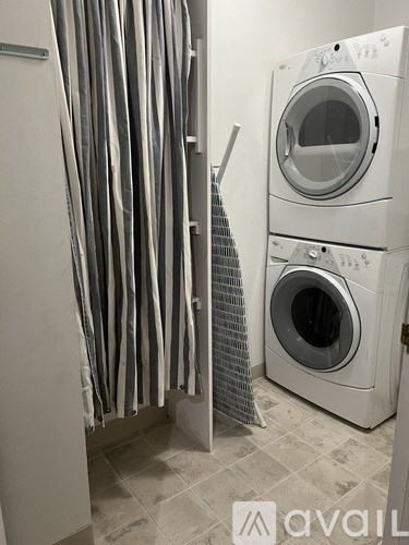A washing machine and dryer in a laundry room.