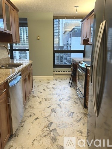 A kitchen with a marble floor and a window overlooking the city.