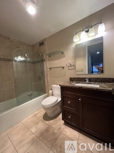 A bathroom with a toilet, sink, and shower.