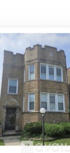 A large, castle-like building with a black door and windows.