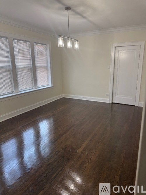A room with wooden floors and a white door.