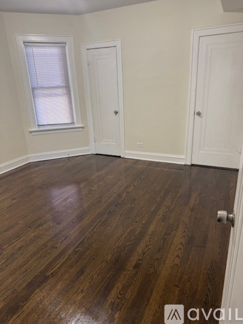 A room with wooden floors and white walls.