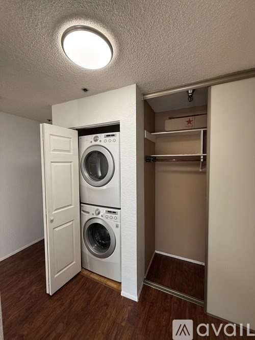 A small laundry room with a washer and dryer.