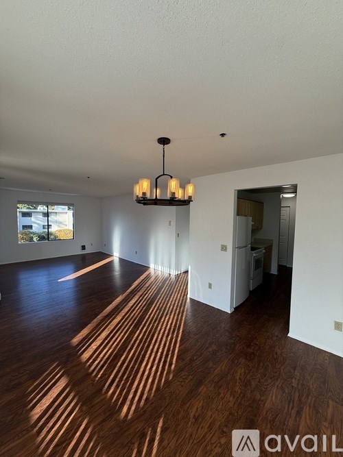 A room with wooden floors and a chandelier.