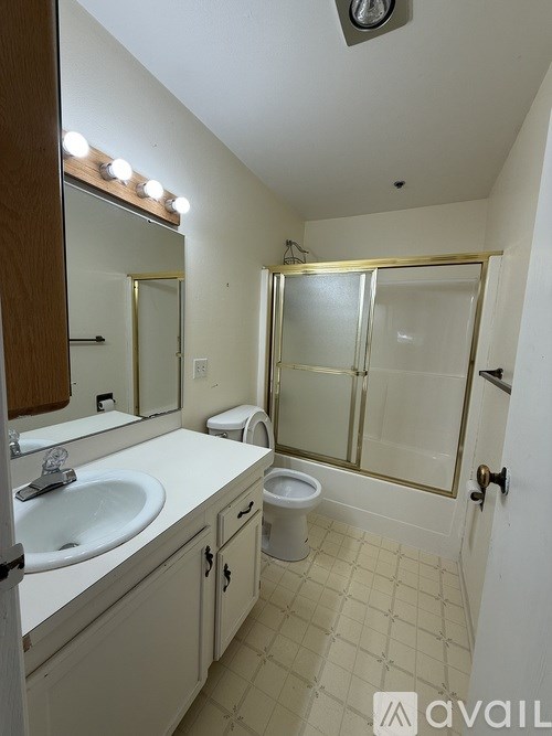 A bathroom with a sink, toilet and shower.