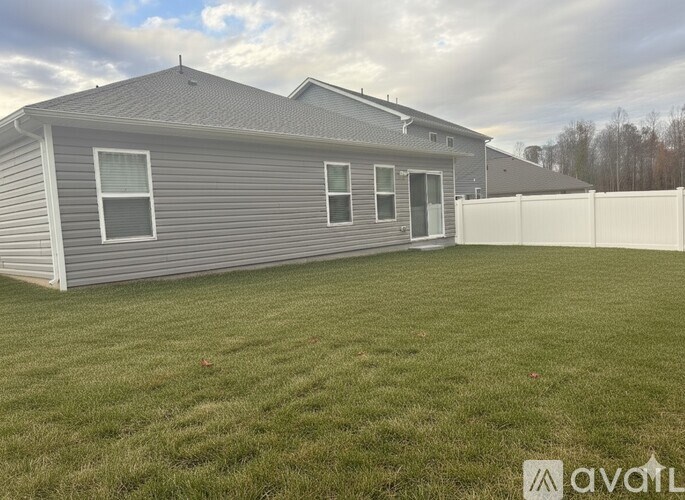 A bedroom with a bed, nightstand, and lamp.