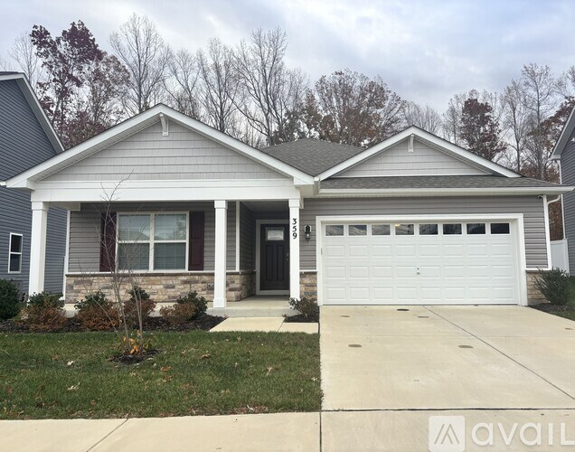 A two-story house with a garage and a front porch.