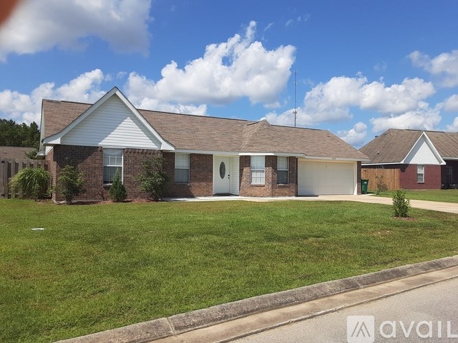 A house with a white roof and a brown brick wall is for sale.