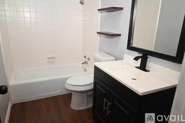 A bathroom with a white toilet, white sink, and a white bathtub.