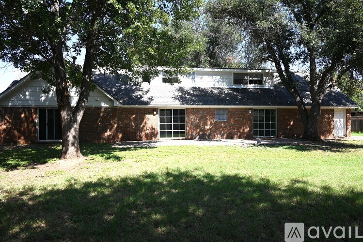 A house with a tree in front of it.