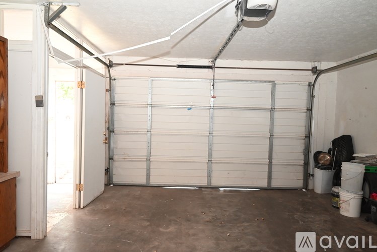A garage with a white door and a white ceiling.