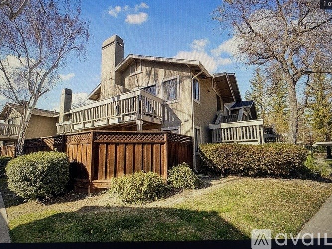 A large house with a balcony and a fence.